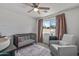 Cozy Bedroom room with crib, rocking chair, ceiling fan, and natural light at 4542 W Villa Theresa Dr, Glendale, AZ 85308