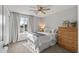 Cozy bedroom featuring natural light, neutral decor, and a wood dresser at 4542 W Villa Theresa Dr, Glendale, AZ 85308