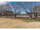 View of the outdoor tennis court at the community park with mature trees in a grassy area at 4542 W Villa Theresa Dr, Glendale, AZ 85308