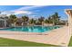 Community swimming pool surrounded by lush landscaping, with a spacious deck at 4542 W Villa Theresa Dr, Glendale, AZ 85308