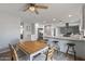 Bright dining area featuring a wooden table, neutral chairs, and an open layout connected to a modern kitchen at 4542 W Villa Theresa Dr, Glendale, AZ 85308