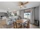 Open concept dining area with a wood table, neutral chairs, and adjacent kitchen with bar seating at 4542 W Villa Theresa Dr, Glendale, AZ 85308