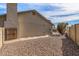 Exterior side view of the home showcasing gravel landscaping, chimney, and architectural details at 4542 W Villa Theresa Dr, Glendale, AZ 85308