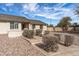 View of the front of the house showing the desert landscaping and brick exterior at 4542 W Villa Theresa Dr, Glendale, AZ 85308