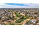 Aerial view of a verdant golf course interspersed within a residential community, offering a unique lifestyle at 4542 W Villa Theresa Dr, Glendale, AZ 85308