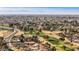 Scenic aerial shot showcasing a golf course integrated into a residential community with mountain views at 4542 W Villa Theresa Dr, Glendale, AZ 85308