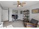 Well-lit home office featuring a ceiling fan, desk, shelving, chair, and decor at 4542 W Villa Theresa Dr, Glendale, AZ 85308