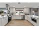 Bright kitchen with stainless steel appliances, white cabinetry, and a large sink with a window view at 4542 W Villa Theresa Dr, Glendale, AZ 85308