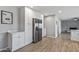 Contemporary kitchen area with white cabinets, stainless steel refrigerator, and sleek countertops at 4542 W Villa Theresa Dr, Glendale, AZ 85308