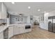 Spacious kitchen featuring a large island with a microwave, white cabinetry, and modern appliances at 4542 W Villa Theresa Dr, Glendale, AZ 85308