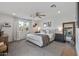 Bright bedroom featuring neutral decor, carpet, ceiling fan and natural light at 4542 W Villa Theresa Dr, Glendale, AZ 85308