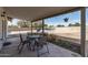 Covered patio with outdoor seating, offering a view of the backyard and pool at 4542 W Villa Theresa Dr, Glendale, AZ 85308