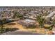 Aerial photograph of community tennis court beside lush landscaped common area, shaded by mature trees at 4542 W Villa Theresa Dr, Glendale, AZ 85308