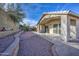 Landscaped backyard with a patio and brick retaining wall at 5153 W Pontiac Dr, Glendale, AZ 85308