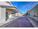 Landscaped backyard with patio, brick walkway, and desert plants at 5153 W Pontiac Dr, Glendale, AZ 85308