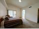 Neutral bedroom with high ceiling, carpet flooring, and sliding glass doors to let in lots of light at 5153 W Pontiac Dr, Glendale, AZ 85308