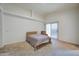 Bedroom with a double bed and sliding door to the backyard at 5153 W Pontiac Dr, Glendale, AZ 85308