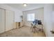 Bedroom with a desk, chair, and double doors leading to a hallway at 5153 W Pontiac Dr, Glendale, AZ 85308