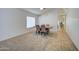 Bright dining room features a table with four chairs and carpet flooring at 5153 W Pontiac Dr, Glendale, AZ 85308