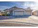 Single-story home with three-car garage and desert landscaping at 5153 W Pontiac Dr, Glendale, AZ 85308