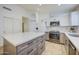 Modern kitchen with light wood cabinets and stainless steel appliances at 5153 W Pontiac Dr, Glendale, AZ 85308