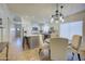 Bright kitchen with island, dining area, and white shaker cabinets at 5153 W Pontiac Dr, Glendale, AZ 85308