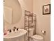 Small bathroom with pedestal sink, toilet and linen storage at 5251 W Posse Dr, Eloy, AZ 85131