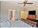 Bedroom with wooden bed frame, TV, and ensuite bathroom at 5251 W Posse Dr, Eloy, AZ 85131