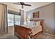 Bedroom with wooden bed frame and ceiling fan at 5251 W Posse Dr, Eloy, AZ 85131