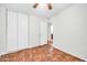 Bedroom with hardwood floors, ceiling fan, and double doors at 5331 W Mescal St, Glendale, AZ 85304