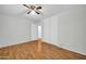 Bedroom with hardwood floors, double doors, and ceiling fan at 5331 W Mescal St, Glendale, AZ 85304