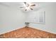 Bedroom with hardwood floors, ceiling fan, and window shutters at 5331 W Mescal St, Glendale, AZ 85304