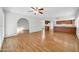 Living room with laminate wood floors and an arched entryway at 5331 W Mescal St, Glendale, AZ 85304