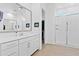 Bright bathroom featuring a large vanity with a sink, a large mirror and walk-in shower with glass doors at 5724 S Coyote Cyn, Mesa, AZ 85212