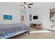 Bedroom with tile floors, ceiling fan, tv, and a sliding glass door to the outdoor area at 5724 S Coyote Cyn, Mesa, AZ 85212