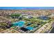 Aerial view of luxurious community pool area with waterslides, lounge chairs, and well-manicured landscaping at 5724 S Coyote Cyn, Mesa, AZ 85212