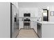 Modern kitchen with stainless steel appliances, white cabinetry, and tile backsplash at 5724 S Coyote Cyn, Mesa, AZ 85212