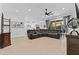 Spacious living room featuring tile floors, a ceiling fan and a comfortable sectional couch at 5724 S Coyote Cyn, Mesa, AZ 85212