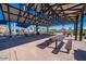 Community pavilion with picnic tables, sun shade, and manicured landscaping at 5724 S Coyote Cyn, Mesa, AZ 85212