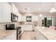 Modern kitchen with white cabinets, granite countertops, and stainless steel appliances at 5836 S 58Th Gln, Laveen, AZ 85339