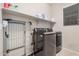 Laundry room with washer, dryer, and shelving at 5836 S 58Th Gln, Laveen, AZ 85339