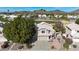 Aerial view of two story house with a desert landscape, golf course, and mountain background at 6282 W Rose Garden Ln, Glendale, AZ 85308