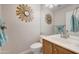 Updated bathroom with wood vanity and decorative mirror at 6282 W Rose Garden Ln, Glendale, AZ 85308