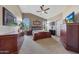 Spacious bedroom with wood furniture and large windows at 6282 W Rose Garden Ln, Glendale, AZ 85308