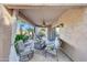 Covered patio with seating area and sheer curtains at 6282 W Rose Garden Ln, Glendale, AZ 85308