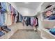 Large walk-in closet with ample shelving and hanging space at 6282 W Rose Garden Ln, Glendale, AZ 85308