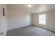 Bright bedroom with carpet flooring and large window at 645 S Warren Rd, Maricopa, AZ 85139