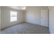 Simple bedroom with carpet flooring and a large window at 645 S Warren Rd, Maricopa, AZ 85139