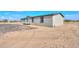 View of the home's back exterior, showing deck and landscaping at 645 S Warren Rd, Maricopa, AZ 85139