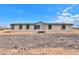 Single-story home with neutral exterior and deck at 645 S Warren Rd, Maricopa, AZ 85139